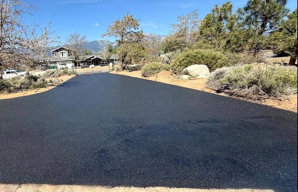 New asphalt driveway with high-desert landscaping and mountains