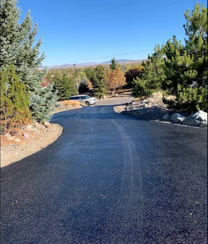 Long residential driveway winding down a hillside